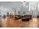 Open-concept living room featuring hardwood floors and leather furniture leading into a dining and kitchen area at 8143 Summit Ridge Dr # 41, Catawba, NC 28609
