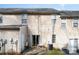 The back of the property features neutral siding, a sliding glass door, and a small patio area at 8460 Summerglen Cir, Charlotte, NC 28227