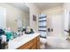Well-lit bathroom features a vanity, toilet, and bathtub with a blue and white shower curtain at 8460 Summerglen Cir, Charlotte, NC 28227