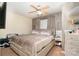 Comfortable bedroom with a bed, ceiling fan, neutral tones and decorative wall accents at 8460 Summerglen Cir, Charlotte, NC 28227