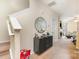 View of the foyer with stairs, cabinet and mirror plus a view of the fireplace in the living room at 8460 Summerglen Cir, Charlotte, NC 28227