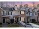 Charming two-story townhome with brick facade, black shutters, landscaped yard, and covered front porch at 8460 Summerglen Cir, Charlotte, NC 28227