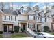 Charming two-story townhome with brick facade, black shutters, landscaped yard, and covered front porch at 8460 Summerglen Cir, Charlotte, NC 28227