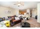 Cozy living room showcasing a modern ceiling fan, a luxurious leather sofa, and an open-concept layout to the kitchen at 8460 Summerglen Cir, Charlotte, NC 28227
