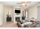 Spacious living room with fireplace, ceiling fan, plush seating and neutral color palette at 8460 Summerglen Cir, Charlotte, NC 28227