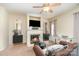 Spacious living room with fireplace, ceiling fan, plush seating and neutral color palette at 8460 Summerglen Cir, Charlotte, NC 28227