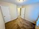 Cozy bedroom featuring neutral walls, carpeted floors, and a bright overhead light fixture at 8900 Moores Chapel Rd, Charlotte, NC 28214