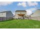 Spacious backyard featuring a well-maintained lawn, fence, and a covered patio with outdoor seating at 921 Von Buren Blvd, Rock Hill, SC 29730