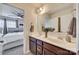 Bright bathroom featuring double sinks, wood cabinets, and a view into the primary bedroom at 921 Von Buren Blvd, Rock Hill, SC 29730
