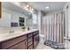 Bright bathroom featuring double sinks with a stylish vanity, toilet, and shower with neutral colored shower curtain at 921 Von Buren Blvd, Rock Hill, SC 29730