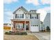 Charming two-story home with a well-manicured lawn and attached garage at 921 Von Buren Blvd, Rock Hill, SC 29730