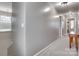 Hallway with neutral walls and carpet, featuring a window to the left and a wooden table to the right at 921 Von Buren Blvd, Rock Hill, SC 29730