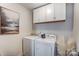 Functional laundry room with washer, dryer, overhead cabinets and modern decor at 921 Von Buren Blvd, Rock Hill, SC 29730