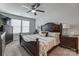 Spacious main bedroom featuring natural light from a window, a ceiling fan, and dark wood furnishings at 921 Von Buren Blvd, Rock Hill, SC 29730