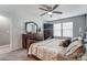 Spacious main bedroom featuring natural light from windows, a ceiling fan, and dark wood furnishings at 921 Von Buren Blvd, Rock Hill, SC 29730