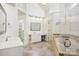 This well-lit bathroom features a vanity, makeup area, tub, and glass shower at 10101 Bayart Way, Huntersville, NC 28078