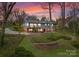 Aerial view of house with backyard fire pit and two patios and walkway on property at 105 Hillside Dr, Davidson, NC 28036