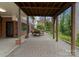 Back patio with wooden dining furniture and exposed wooden supports on the ceiling at 105 Hillside Dr, Davidson, NC 28036