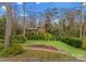 Landscaped backyard featuring mature trees, green lawn, terraced garden, and lower area for lounge at 105 Hillside Dr, Davidson, NC 28036