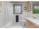 Bright bathroom with tile floor, white walls, and window view to outside at 105 Hillside Dr, Davidson, NC 28036