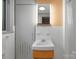 Modern bathroom with white sink, white tiled wall and door on the left at 105 Hillside Dr, Davidson, NC 28036