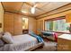 Bright bedroom featuring a built-in vanity, a window with a view of the trees, and hardwood floors at 105 Hillside Dr, Davidson, NC 28036