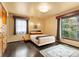 Bedroom with hardwood floors, large windows, and neutral decor at 105 Hillside Dr, Davidson, NC 28036