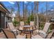 Outdoor dining area with table and chairs surrounded by mature trees at 105 Hillside Dr, Davidson, NC 28036