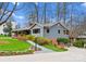 Inviting home with a well-maintained lawn and colorful landscaping, showcasing curb appeal and a backyard deck at 105 Hillside Dr, Davidson, NC 28036