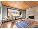 Bright living room featuring a stone fireplace, hardwood floors, and large windows providing ample natural light at 105 Hillside Dr, Davidson, NC 28036