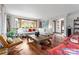 Sunlit living room with hardwood floors, large windows, and comfortable seating at 105 Hillside Dr, Davidson, NC 28036