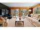 Cozy living room with large windows, comfortable seating, and access to deck at 105 Hillside Dr, Davidson, NC 28036