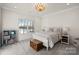 Bright bedroom with a lake view, a cozy bed, and charming decor at 111 Kent Ct, Mooresville, NC 28117
