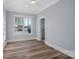 Bright bedroom with a large window overlooking a lake, hardwood floors, and neutral walls at 111 Kent Ct, Mooresville, NC 28117