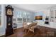 Dining area features large windows with lake views, wood table with chairs, and custom cabinetry at 111 Kent Ct, Mooresville, NC 28117