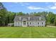 Charming single story home featuring gray siding, dormer windows, a manicured lawn, and a beautiful blue sky at 111 Kent Ct, Mooresville, NC 28117