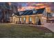 Charming home showcasing meticulous landscaping, a welcoming entrance, and a spacious three car attached garage at 111 Kent Ct, Mooresville, NC 28117