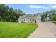 Lovely home featuring siding, dormer windows, a large lawn, and a three car garage at 111 Kent Ct, Mooresville, NC 28117