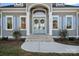 Elegant home entrance featuring a double door entry, decorative wreaths and stylish shutters at 111 Kent Ct, Mooresville, NC 28117