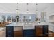 Bright kitchen features a large island with pendant lighting, stainless steel appliances, and scenic views at 111 Kent Ct, Mooresville, NC 28117