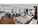 Bright kitchen open to dining area, featuring a large island, white cabinetry, and hardwood floors at 111 Kent Ct, Mooresville, NC 28117