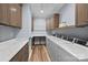 Well-organized laundry room with front-loading washers and dryers, ample counter space, and storage cabinets at 111 Kent Ct, Mooresville, NC 28117