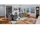 Sun-filled living room with fireplace, bookshelves, hardwood flooring, and scenic outdoor views at 111 Kent Ct, Mooresville, NC 28117
