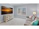 Comfortable living room with a brown couch, a dresser, and a large window with a view of the trees at 111 Kent Ct, Mooresville, NC 28117
