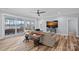 Bright living room with lake view through sliding glass doors, stylish decor, and hardwood floors at 111 Kent Ct, Mooresville, NC 28117