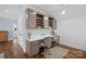 Comfortable office space with built-in cabinets, a desk, and hardwood flooring at 111 Kent Ct, Mooresville, NC 28117