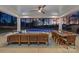 Inviting outdoor living space featuring comfortable seating, dining area, and scenic pool and lake views at 111 Kent Ct, Mooresville, NC 28117