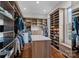 Spacious walk-in closet with custom shelving, an island, and hardwood flooring at 111 Kent Ct, Mooresville, NC 28117