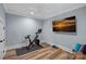 Workout room featuring an exercise bike, dumbbells, a flatscreen TV, and hardwood floors at 111 Kent Ct, Mooresville, NC 28117
