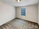 Carpeted bedroom with a large window offering natural light at 120 Cadbury Ln, Fort Mill, SC 29715